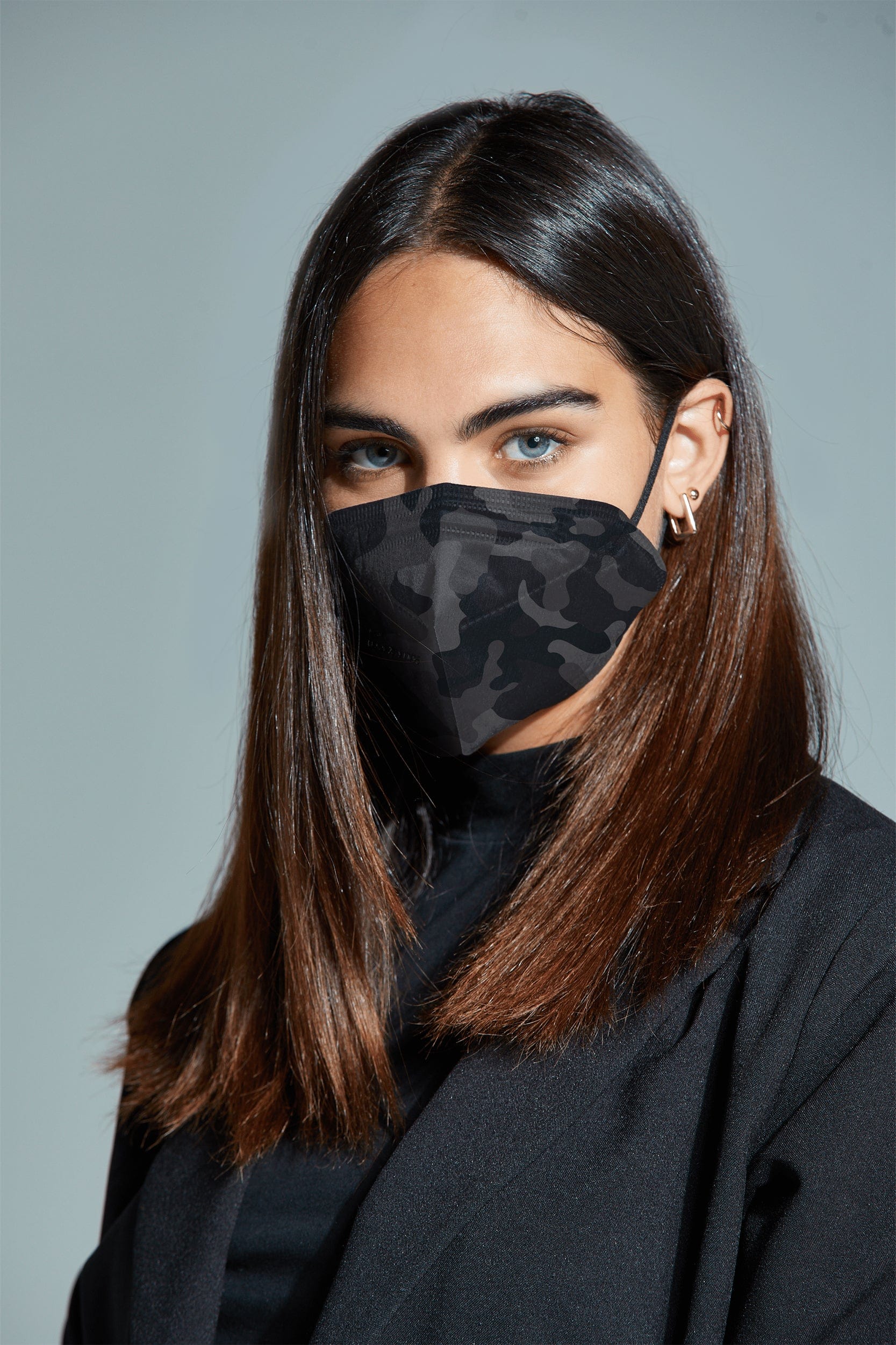 Woman wearing stylish Black Camo printed KN95 face mask, with high quality breathable fabric.