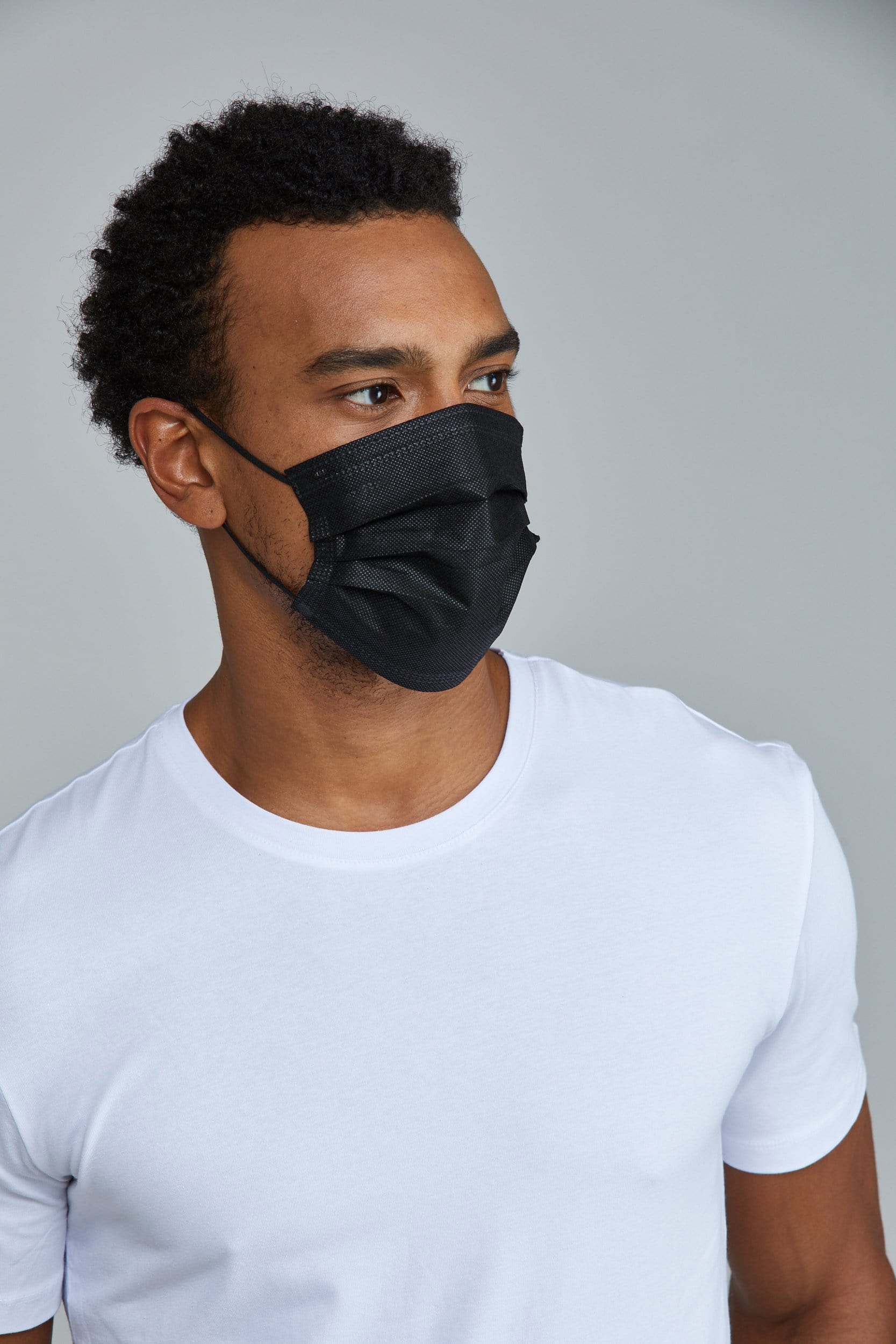 Man wearing stylish Black Pleated face mask, with high quality breathable fabric. 