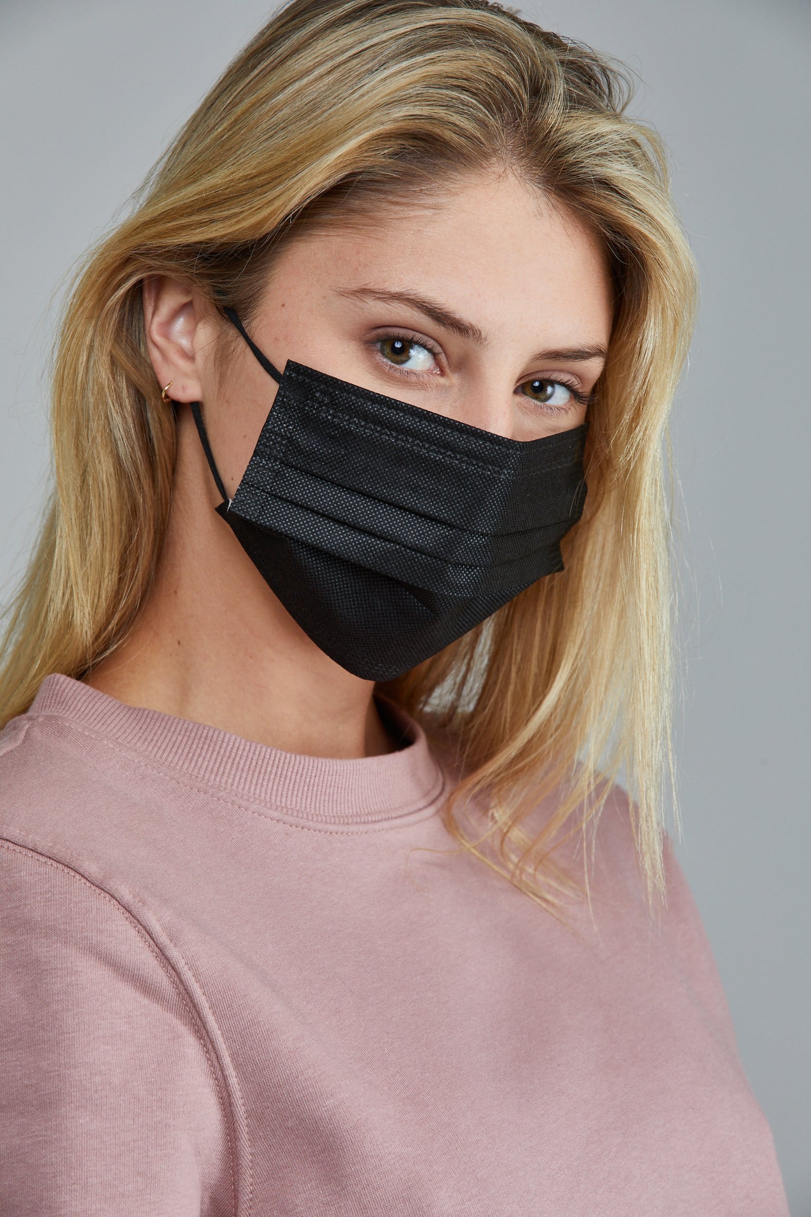 Woman wearing stylish Black Pleated face mask, with high quality breathable fabric. 