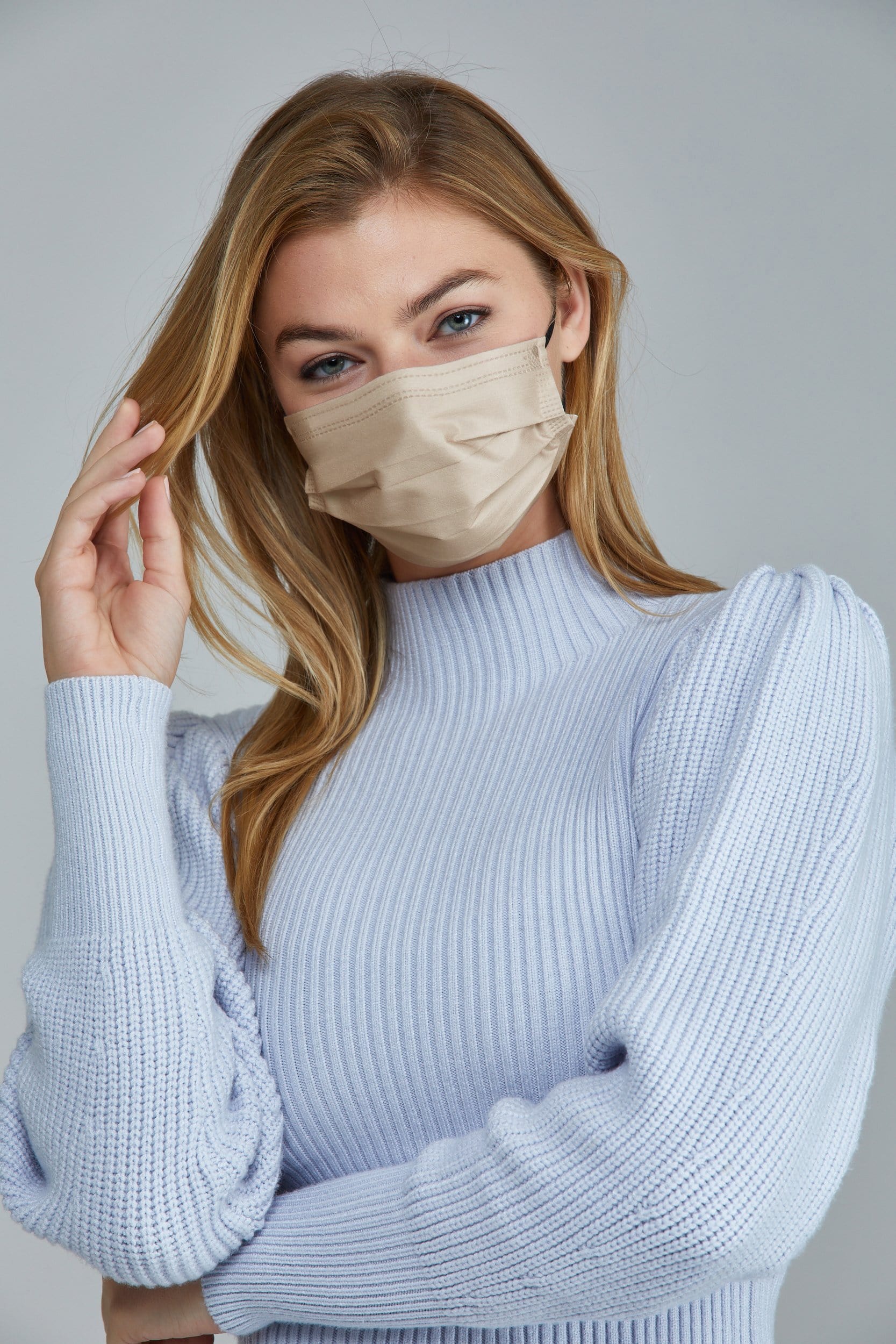 Woman wearing stylish Off White Pleated face mask, with high quality breathable fabric. 