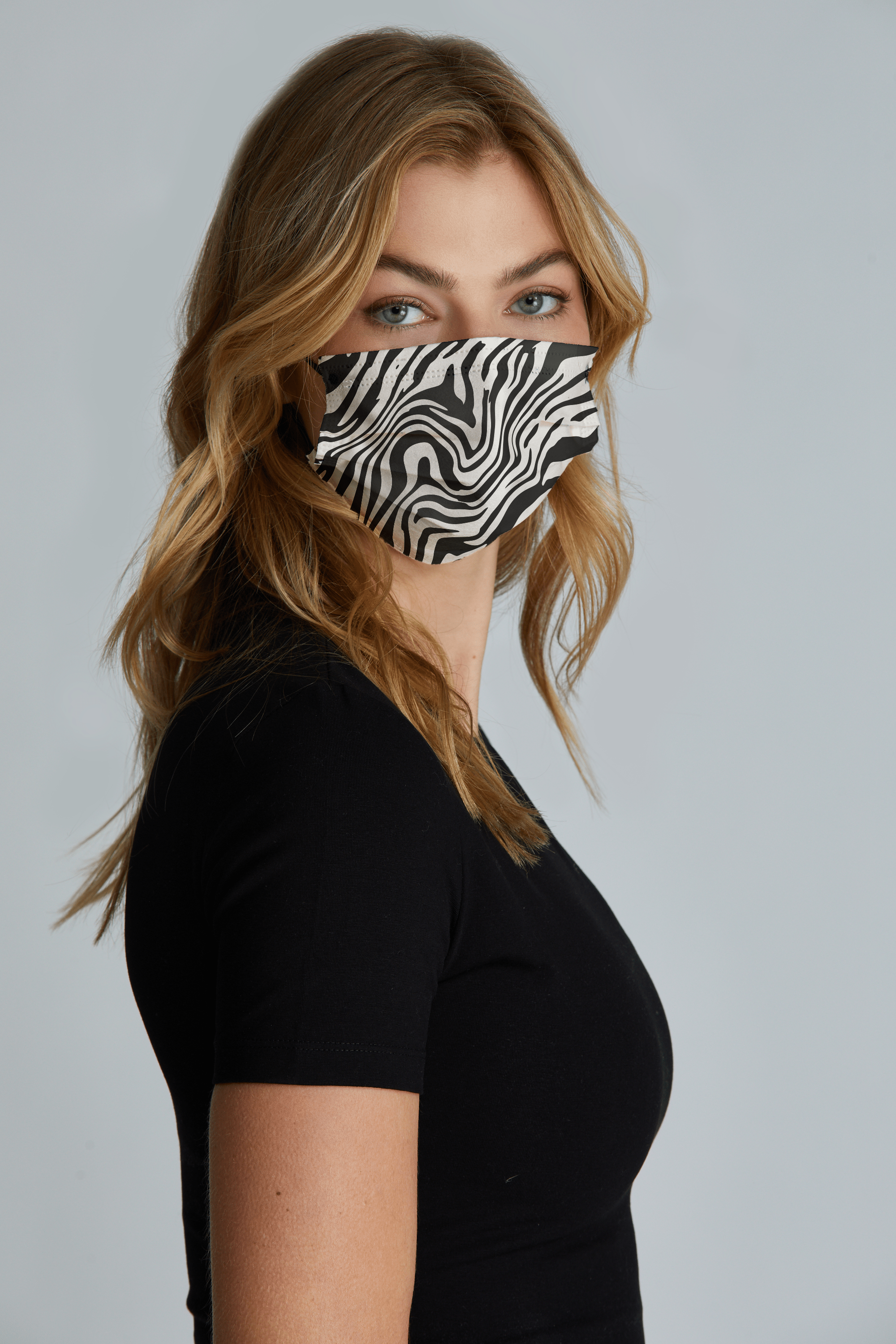 Woman wearing stylish Zebra Printed Pleated face mask, with high quality breathable fabric. 
