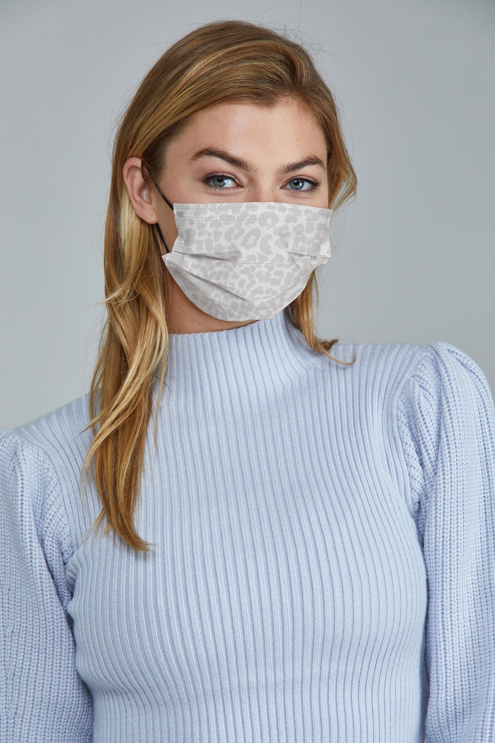 Woman wearing stylish White Leopard Printed Pleated face mask, with high quality breathable fabric. 