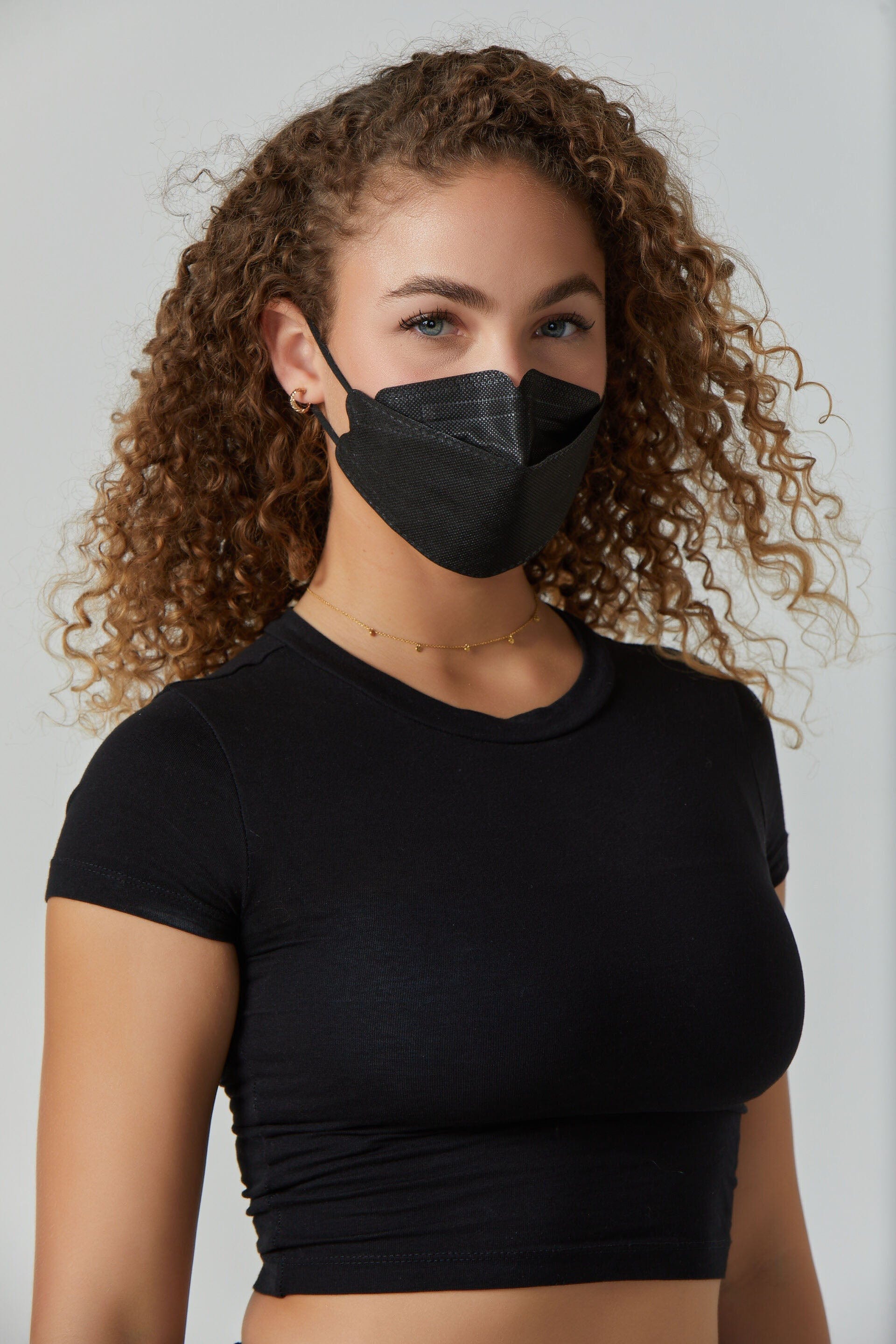 Woman wearing stylish Black KF94 face mask, with high quality breathable fabric. 