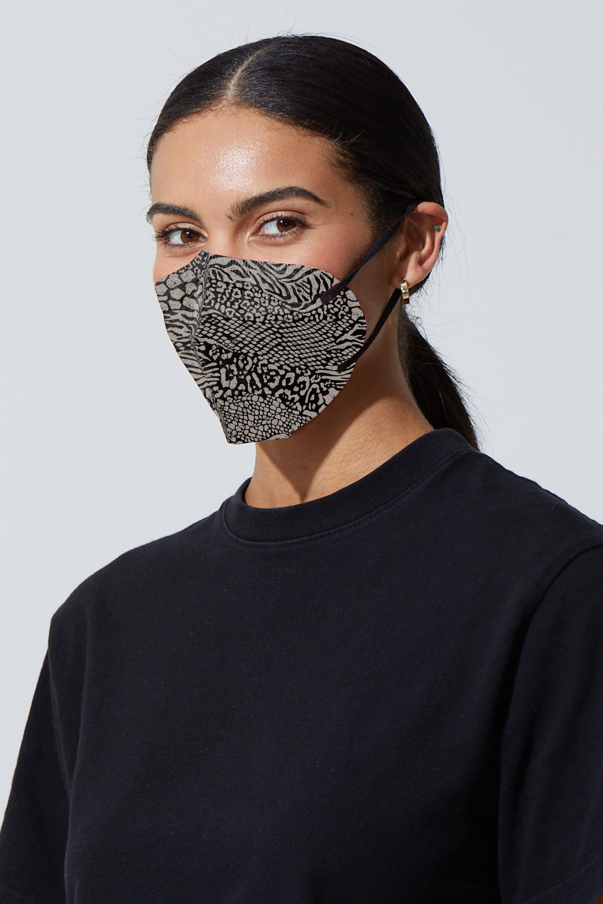 Woman wearing stylish Animal Print KN95 face mask, with high quality breathable fabric. 
