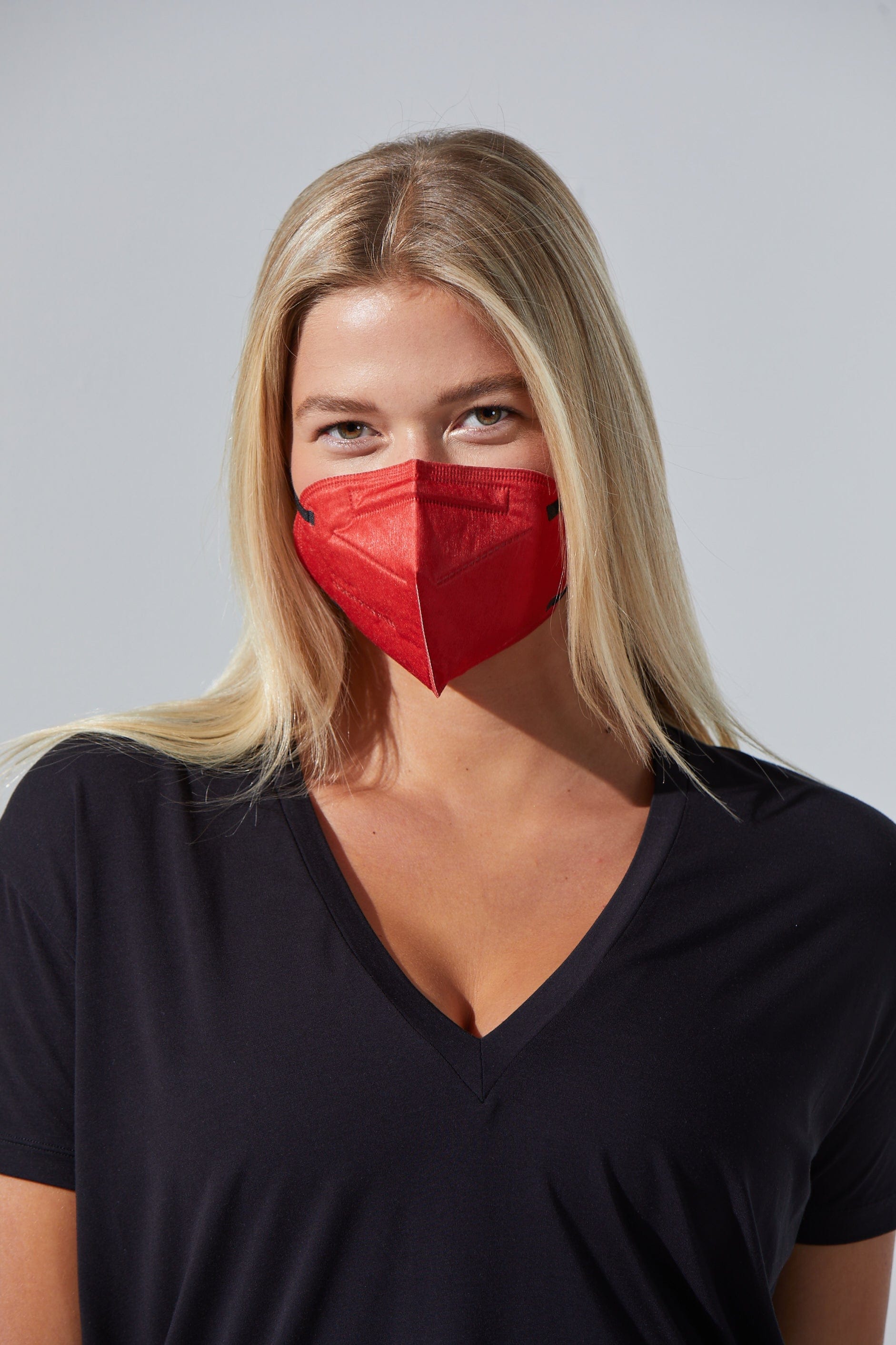 Woman wearing stylish Bright Red KN95 face mask, with high quality breathable fabric. 