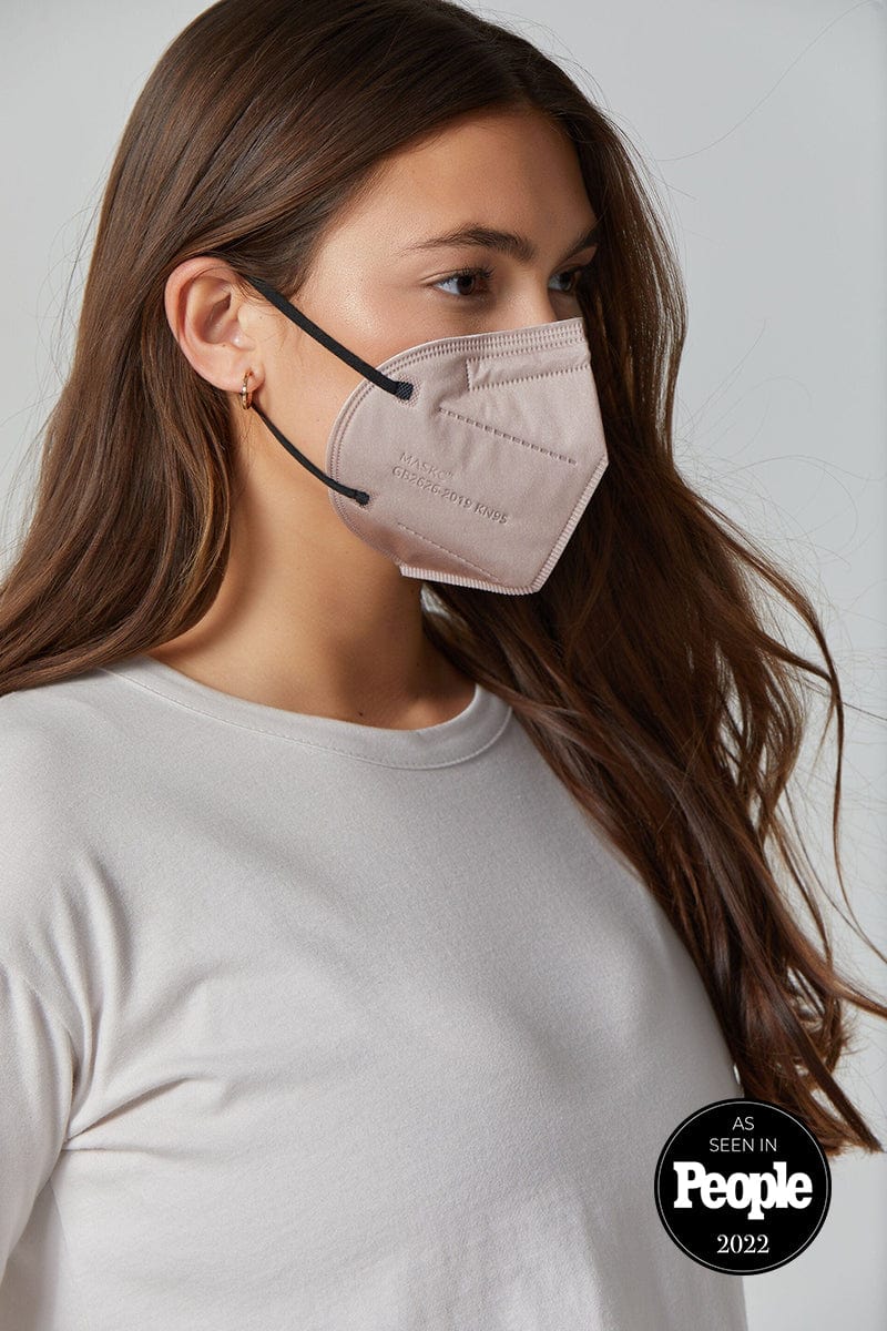 Woman wearing stylish Light Brown KN95 face mask, with high quality breathable fabric. 