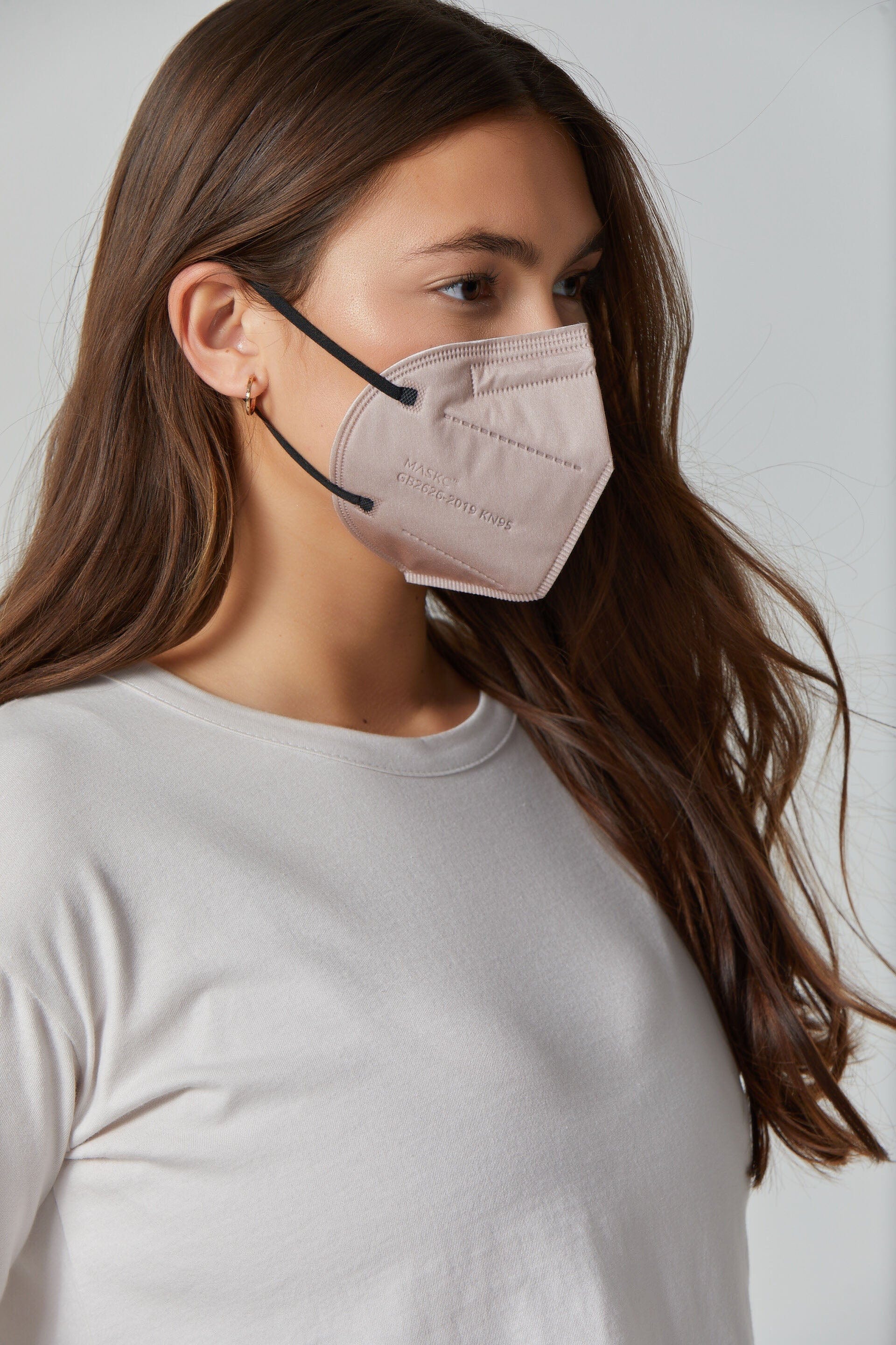 Woman wearing stylish Light Brown KN95 face mask, with high quality breathable fabric. 