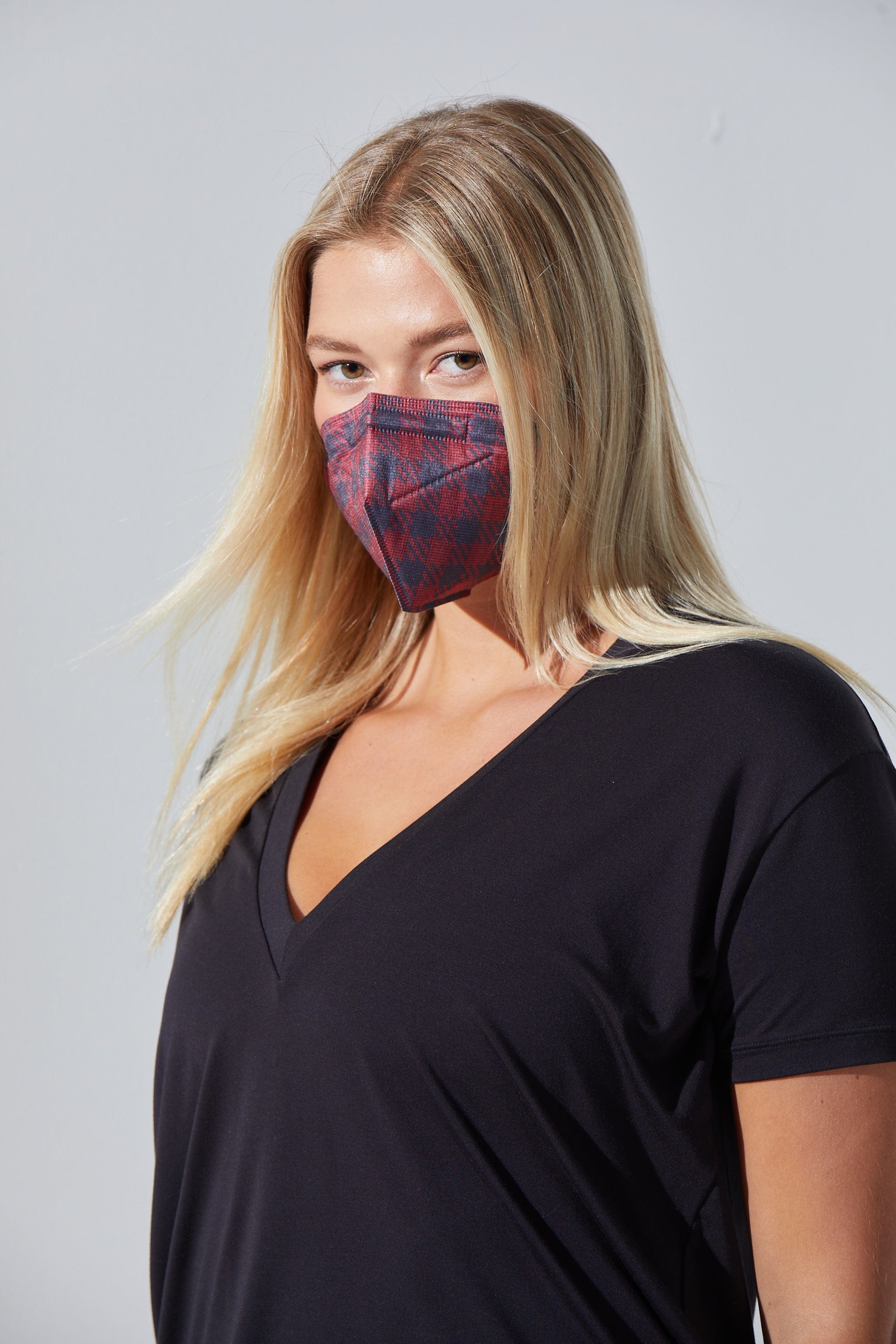 Woman wearing stylish Red & Black Plaid KN95 face mask, with high quality breathable fabric. 