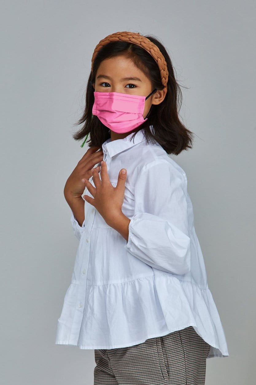 Child wearing stylish Light Pink Pleated face mask, with three layers & high quality breathable fabric. 