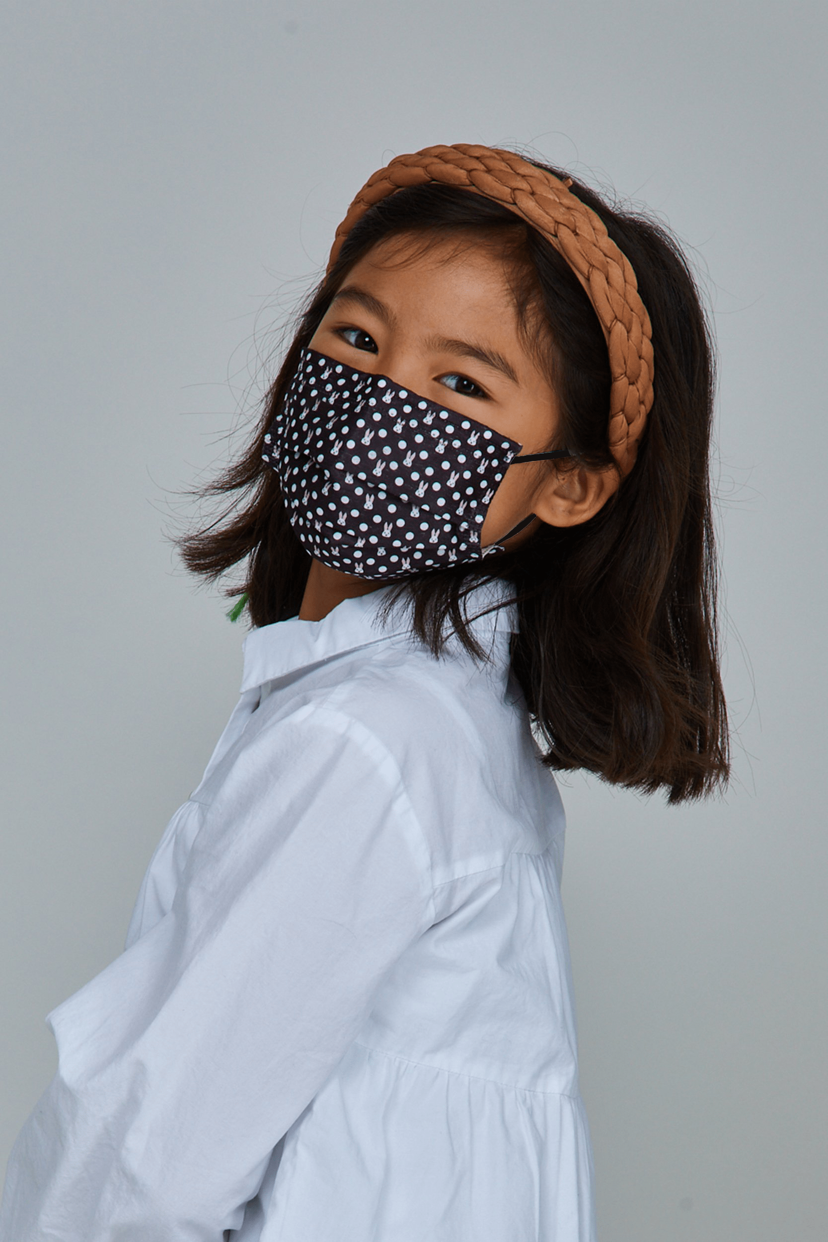 Child wearing stylish Polka Dot Bunny Pleated face mask, with three layers & high quality breathable fabric. 